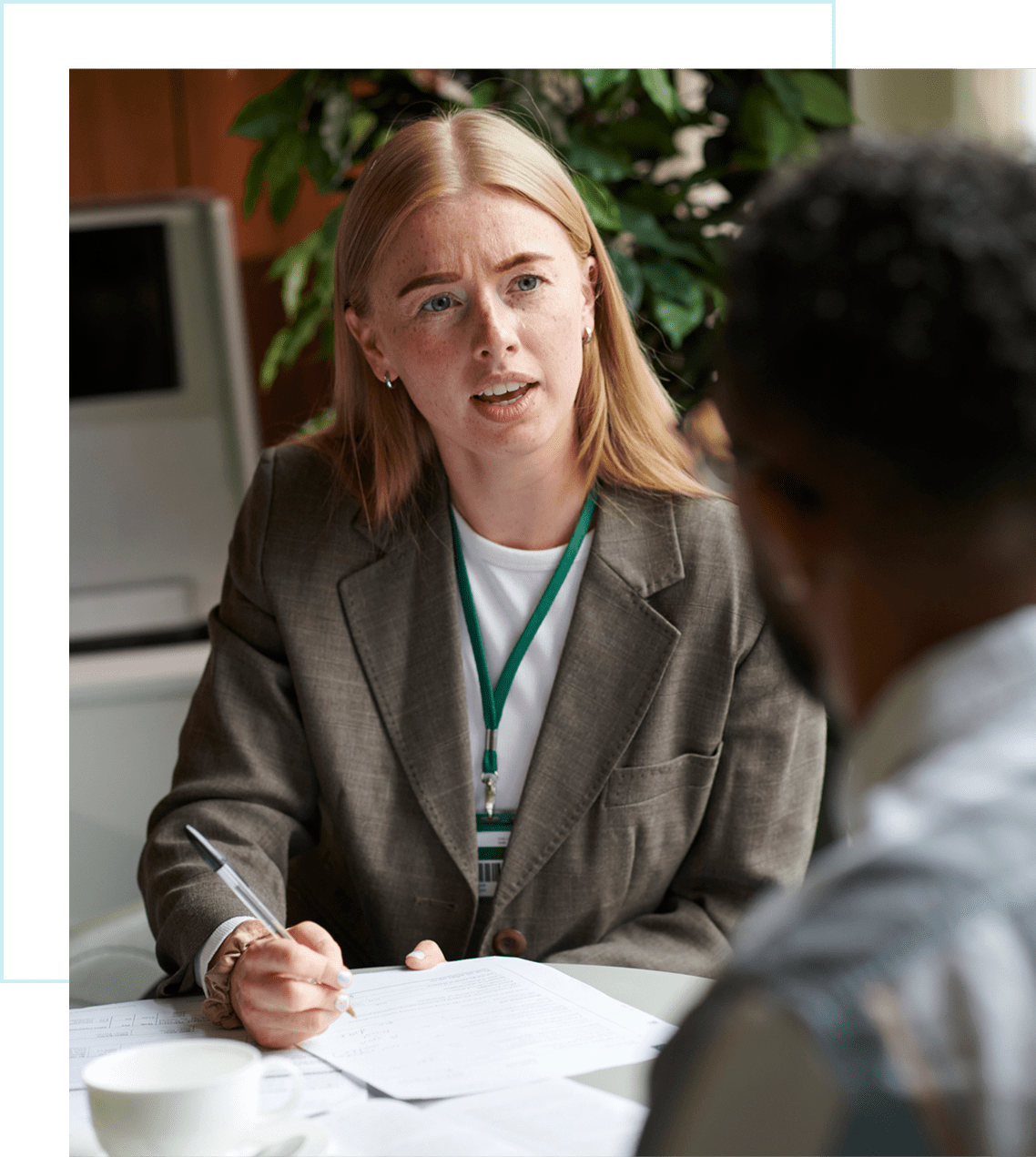 Woman in discussion at a meeting table.